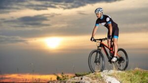 a man riding his enduro mountain bike over hill