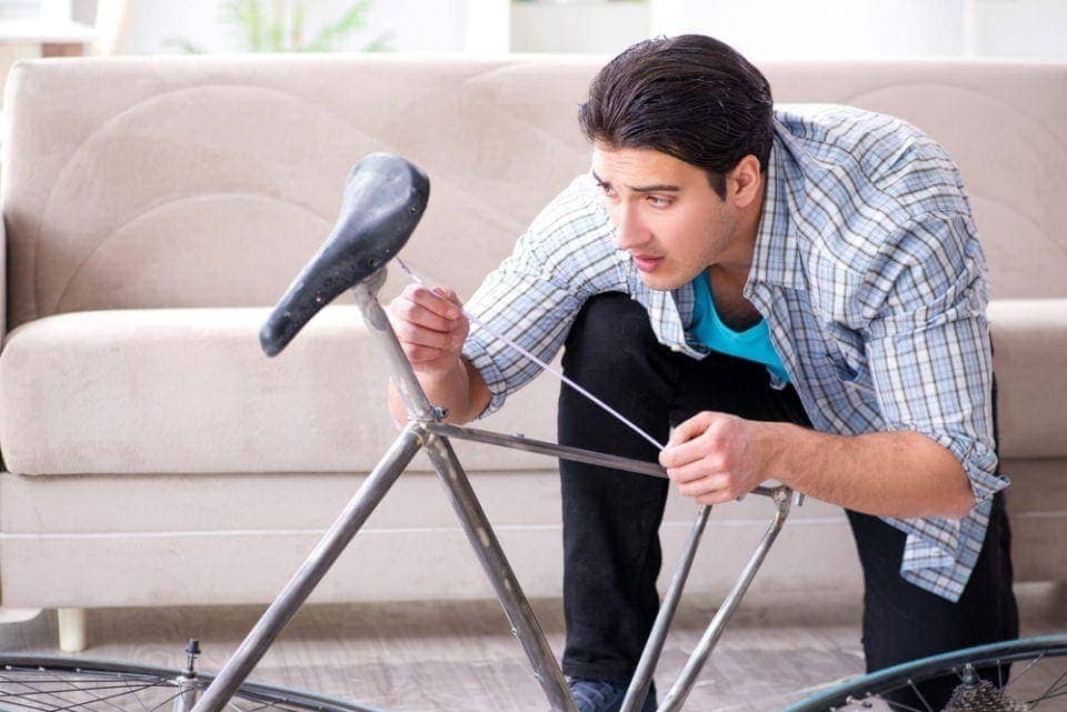 man measuring the size of his bike frame