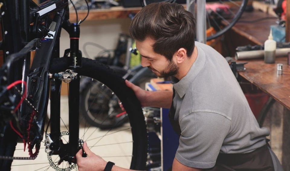 man holding a bike wheel