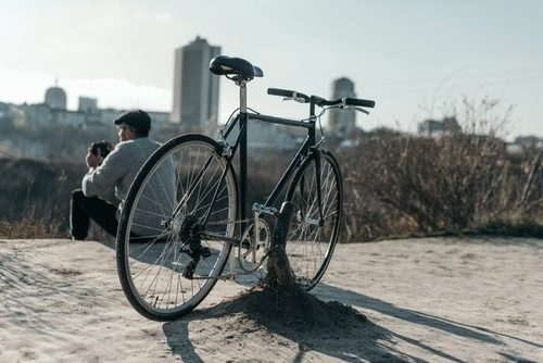 close up of hybrid bike with the city in the background