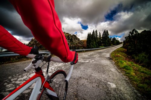 close up of a man riding a road bike
