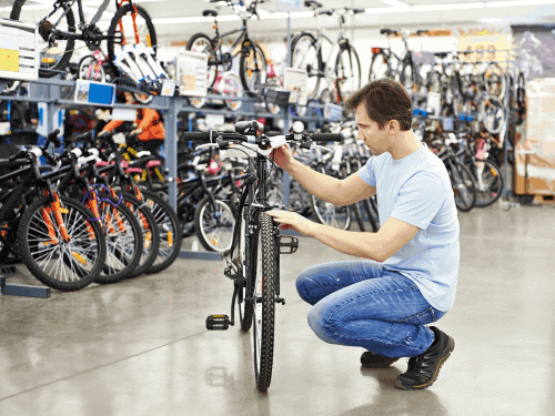man checking a mountain bike