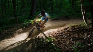a man on his mountain bike taking a curve in the forest