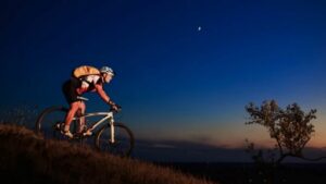a man riding his mountain bike at night