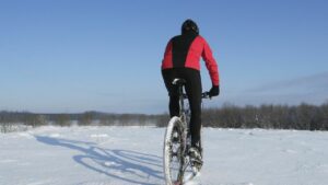 man riding mountain bike through the snow