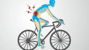 a man on a road bike showing an area of back pain