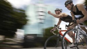 two people riding their road bikes in a race