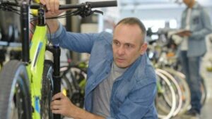 Man checking the size of his bikeMan checking the size of his bike