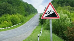 steep hill with steep warning traffic sign