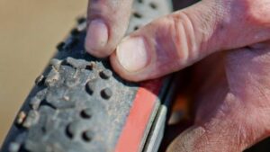 man checking his road bike tyres