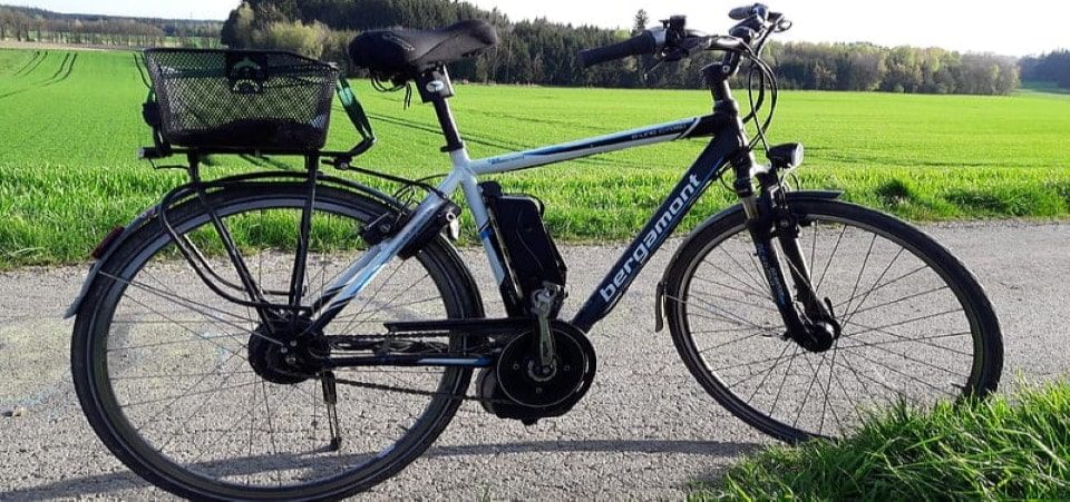a black and white electric mountain bike on the road