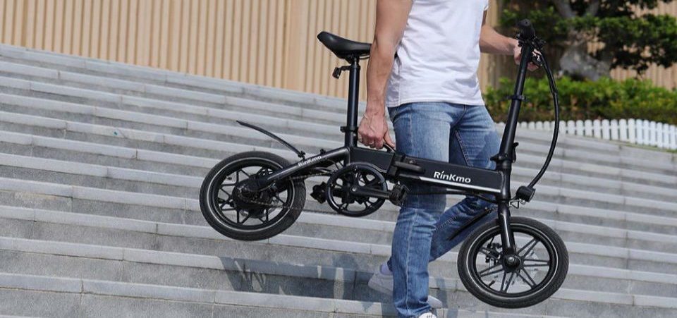 a boy charging his electric bicycle