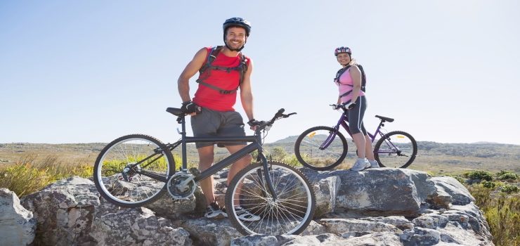 a couple with their bikes on the rock