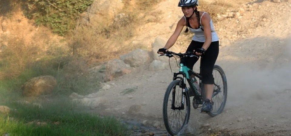 a girl going down the hill on her bike