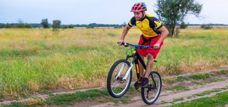 a guy lifting his front tire off his mountain bike