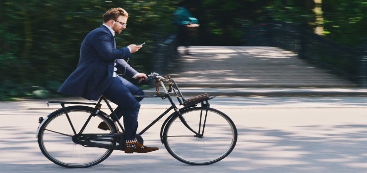 a man going in road bike to his house
