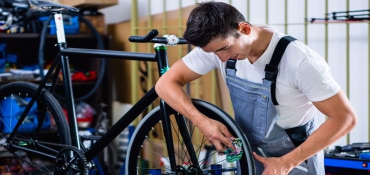 a man repair a road bike tire