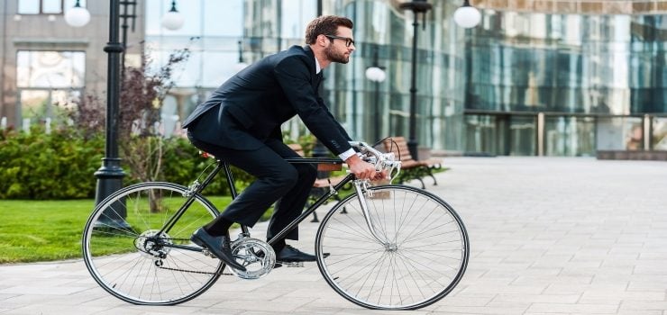 a man riding his road bike to the work