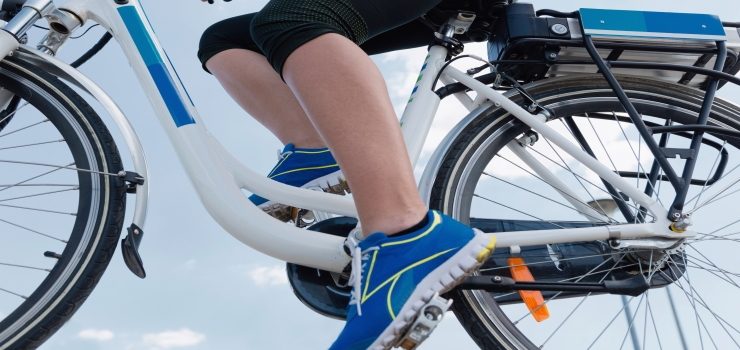 woman pedaling electric bicycle