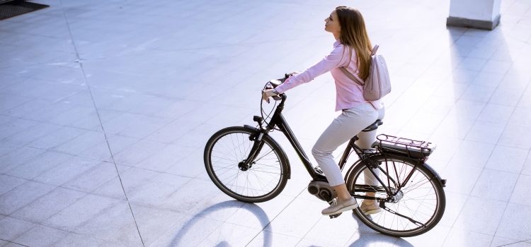 young woman with city electric e-bike